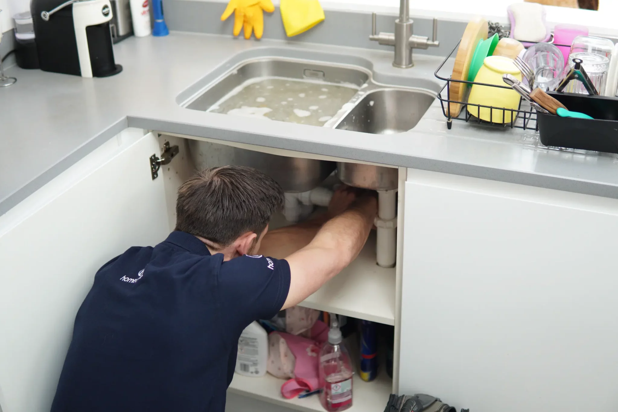 Plumber fixing a leaking sink in Crouch end