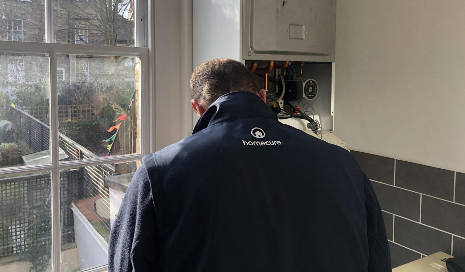 A gas engineer in London working in the kitchen