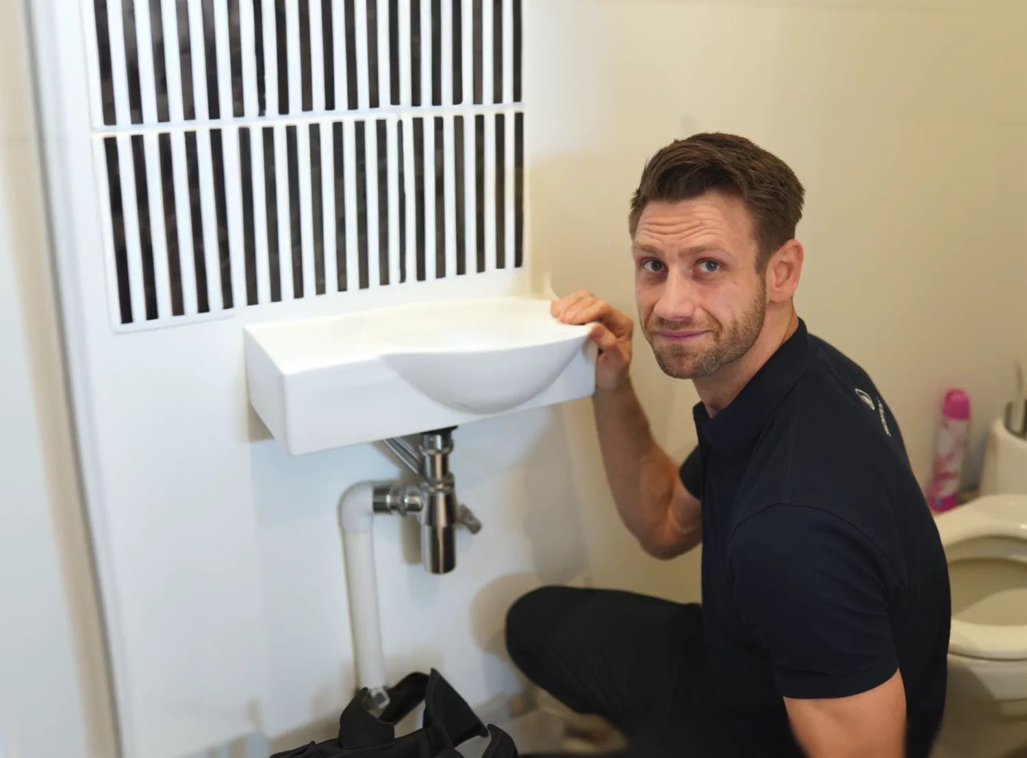 Chiswick Plumber working on sink