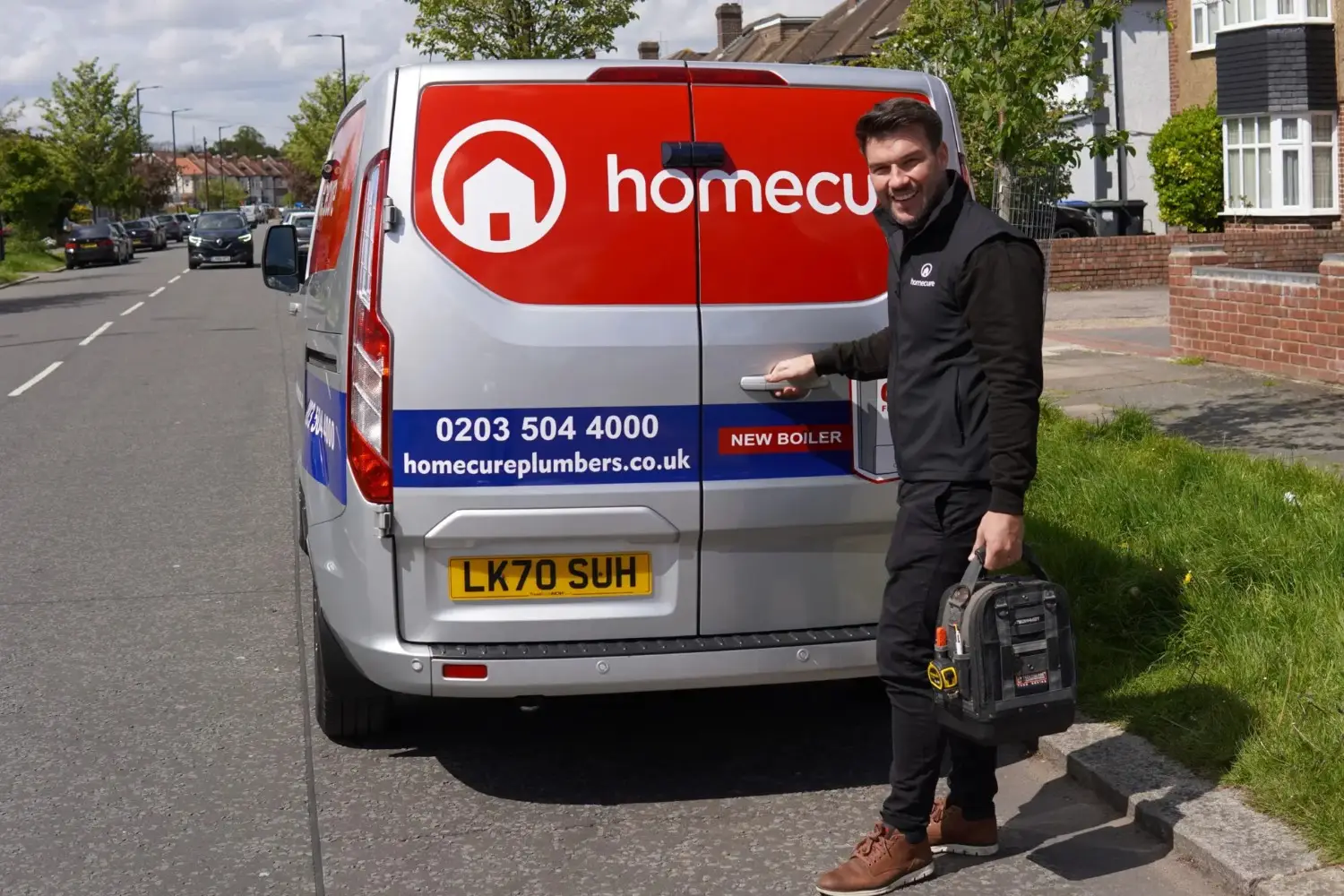 Homecure heating engineer next to a van in London