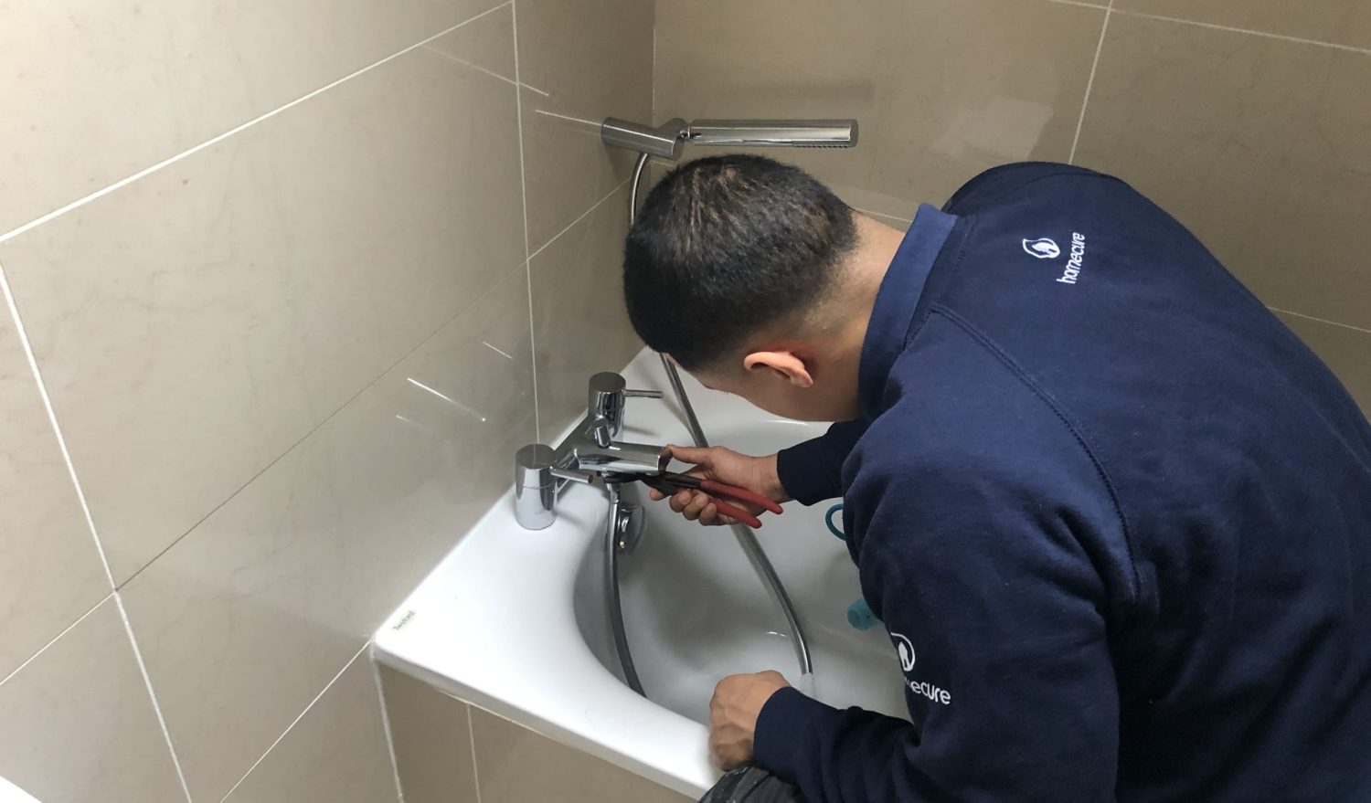 Our emergency plumber in Chiswick fixing a tap